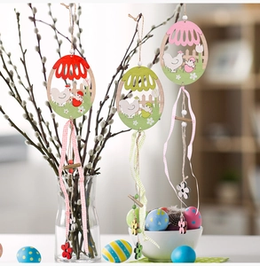 Detailed view of colorful wooden Easter ornaments with chicken patterns on tree branches