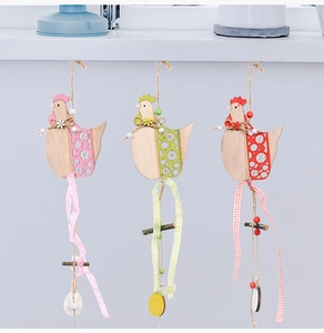 Detailed view of three colorful wooden Easter hen ornaments with intricate hollow patterns