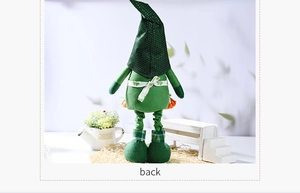 Rear view of St. Patrick's Day gnome doll with green clover ribbon and telescopic legs