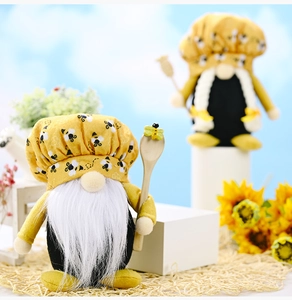 Pair of bumble bee chef gnomes with yellow hats and spoons in a garden setting