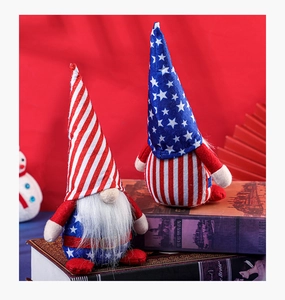 Detail of 4th of July gnomes with American flag patterns on rustic book decor