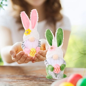 Close-up of handmade Easter rabbit gnomes being held in hands for holiday decoration