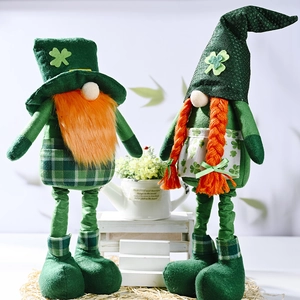 Pair of St. Patrick's Day gnomes with green clover patterns and orange beards on a stand