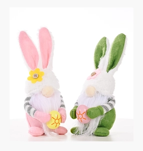 Detail of Easter gnome plush with bunny ears holding decorative eggs and soft beard