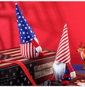 Close-up of Independence Day gnomes with American flag patterns on vintage books and trunk