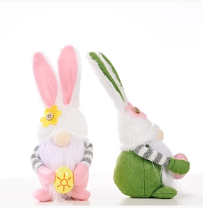 Detail of plush Easter gnomes with bunny ears and colorful eggs for home decoration