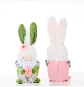 Close-up of Easter gnomes plush set with bunny ears and painted egg on white background