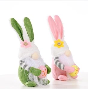 Detail of two Easter gnomes with rabbit ears, white beards and colorful painted eggs