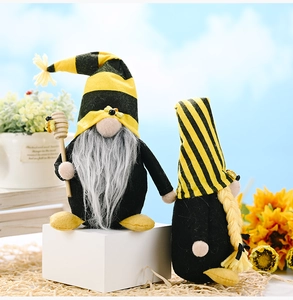 Detail of bee gnomes with striped hats, wooden honey dipper, and faux fur beard texture
