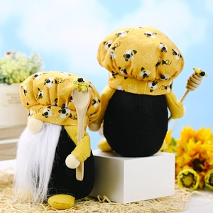 Yellow bee-themed gnomes set with chef hats and wooden accessories on white display