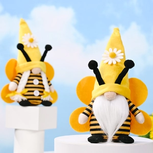 Bee-themed gnome plush toys with yellow striped hats and wings on display stands