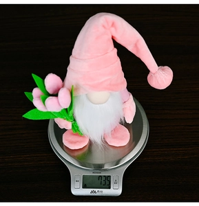 Detailed view of pink tulip gnome plush decoration on a scale weighing 73.5g