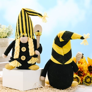 Pair of bumble bee Christmas gnomes with yellow stripes and sunflower decor