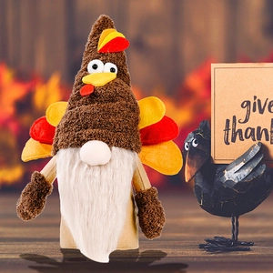 Detail of a Thanksgiving turkey gnome ornament with felt wings on a cozy autumn background
