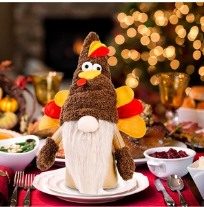 Detail of Thanksgiving turkey gnome plush with colorful tail feathers on a festive table