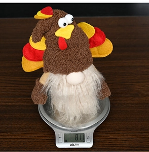 Detailed view showing the plush Thanksgiving turkey gnome weight on a digital scale