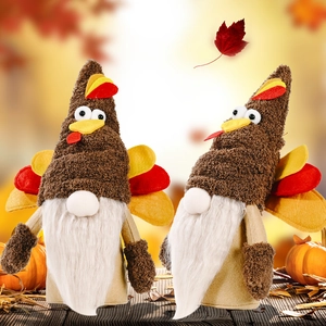 Pair of Thanksgiving turkey gnomes plush decorations with autumn pumpkin background