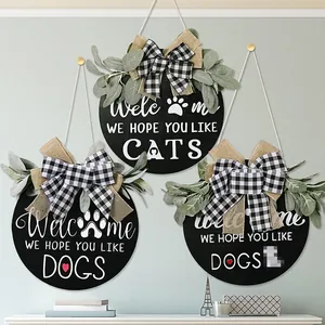 Detailed view of rustic wooden door signs with burlap bows and eucalyptus greenery decor