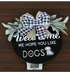 Close-up of rustic welcome sign for dog lovers showing 270g weight on scale