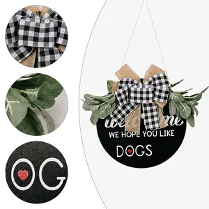 Rustic wooden welcome door wreath with black and white plaid bow and green foliage