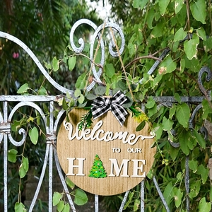 Rustic wood round welcome door sign with buffalo plaid bow and seasonal 3D Christmas tree