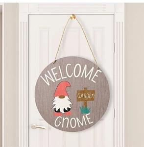 Macro shot of a wooden Garden Gnome welcome sign featuring a cute gnome on a white door