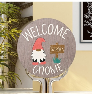 Detailed view of wooden Welcome Gnome plaque with grey wood grain and garden theme