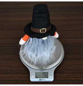 Weight measurement of a Halloween gnome plush with wizard hat on a digital scale