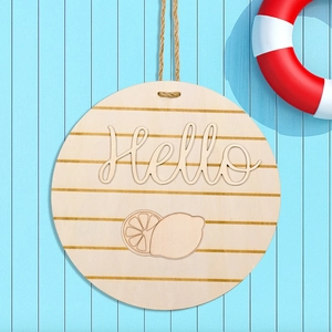 Round wooden door hanger with 3D Hello sign and lemon design on a blue striped wall