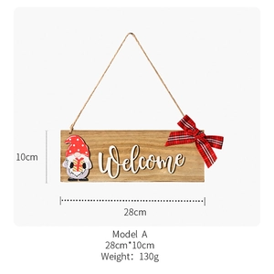 Close-up of wooden welcome sign with red gnome motif and buffalo plaid bow decoration