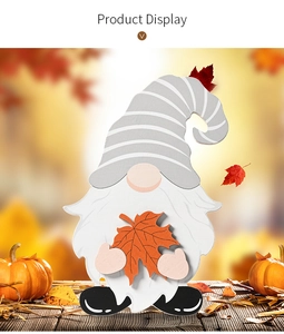 Detailed view of autumn gnome wooden decor with maple leaf in fall themed scene