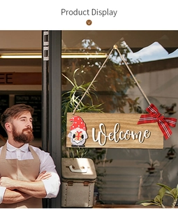 Detail of wooden welcome sign featuring a Christmas gnome and red plaid ribbon bow