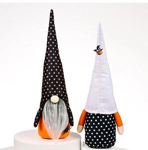 Close-up of Halloween gnomes with spider and pumpkin details on white display stand
