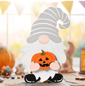 Gnome figurine detail with striped hat and pumpkin lantern for Halloween decor