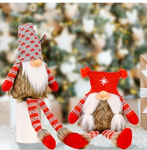Detail showing two plush Christmas gnomes with knitted hats and faux fur on a soft carpet
