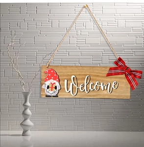 Detail of wooden welcome sign with festive gnome, red polka dot hat and buffalo plaid bow