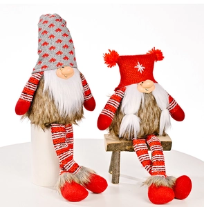 Close-up of two Christmas gnomes with knitted hats and faux fur on display stands