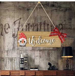 Detail of wooden welcome sign with Christmas gnome and red-black checkered bow knot