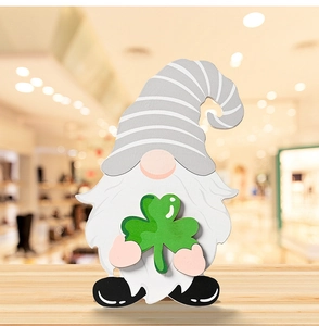 Detail showing a St. Patrick's Day wooden gnome ornament holding a green shamrock leaf
