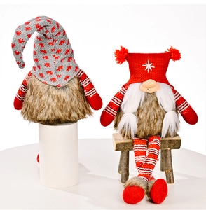 Detailed close-up of knitted Christmas gnomes with long striped legs and plush faux fur bodies