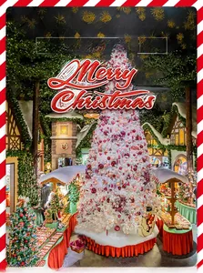 Close-up of white Christmas tree decorated with red and pink festive ornaments
