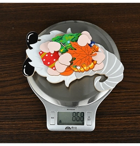 Detailed view of lightweight DIY holiday wood gnome pendants on scale weighing 86.8g