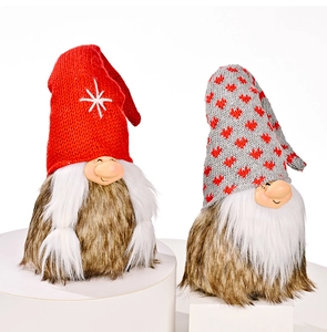Close-up of knit Christmas gnomes with snowflake and heart patterns on white stands
