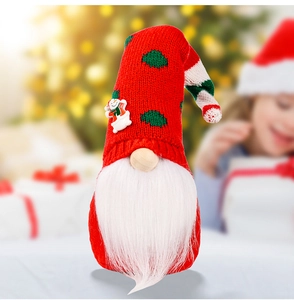 Detail of Christmas gnome with knitted hat and snowman patch in festive home setting