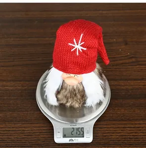 Detail showing a Christmas gnome ornament weight at 215.5g on a digital scale