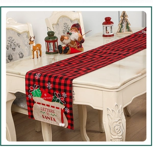 Close-up of red and black buffalo plaid Christmas table runner with festive embroidery