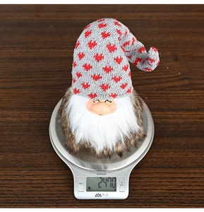 Detailed view of handmade Christmas gnome ornament showing weight of 247g on a digital scale