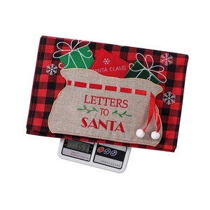 Detail of red and black plaid Christmas envelope decor with Letters to Santa embroidery