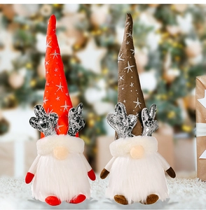 Detail of light-up Christmas gnomes with silver antlers and plush white beards
