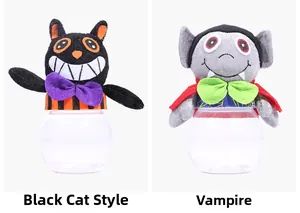 Detail view of Black Cat and Vampire candy jars with plush tops and clear round bases